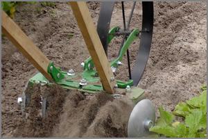 garden size disc harrow throwing soil