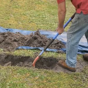 removing loose soil from the bottom of a trench